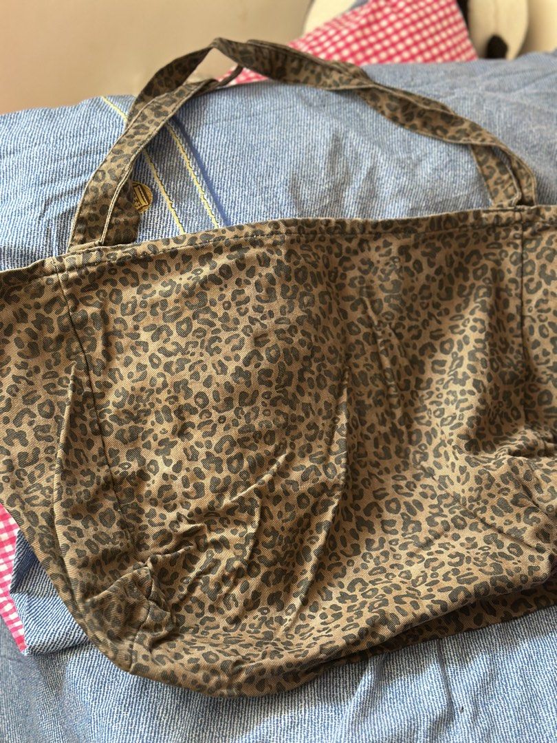 Leopard Print Canvas Tote Bag Shoulder Bag (Category: Tote Bags) located in Batangas. Submitted by enyahsnivl56498 (Listing ID 1465183563, Image 1). Description: - Stylish brown and black leopard print design - Made from durable and sturdy canvas fabric - Comfortable and secure double shoulder straps - Convenient interior slip pocket for small essentials - Clean fabric lining inside the main compartment - Versatile everyday casual bag for daily u