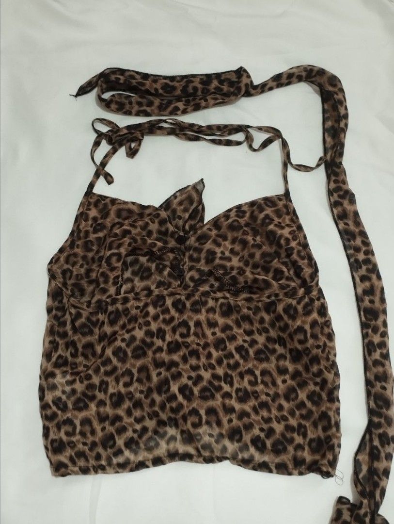 Leopard Print Halter Top with Choker Detail (Category: Sleeveless) located in Manila. Submitted by nicole_alega (Listing ID 1465218192, Image 3). Description: - Style: Leopard print halter top with a matching attached choker - Details: Deep V-neckline and cute ruffled hem at the front - Material: Lightweight, silky smooth fabric - Condition: Worn only once for a quick photo, like new - Styling tip: Pairs effortlessly with your favorite blue jeans