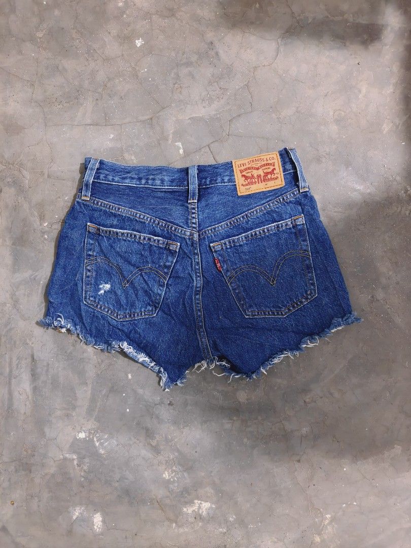 Levi's 501 Original Distressed Denim Shorts (Category: Shorts) located in Baliuag. Submitted by endiyos7 (Listing ID 1465295339, Image 2). Description: - Brand: Levi's 501 - Wash: Medium blue - Closure: Classic button fly with copper hardware - Style: Raw frayed hem with intentional distressing and rips - Details: Signature back patch and iconic red tab on the back pocket.