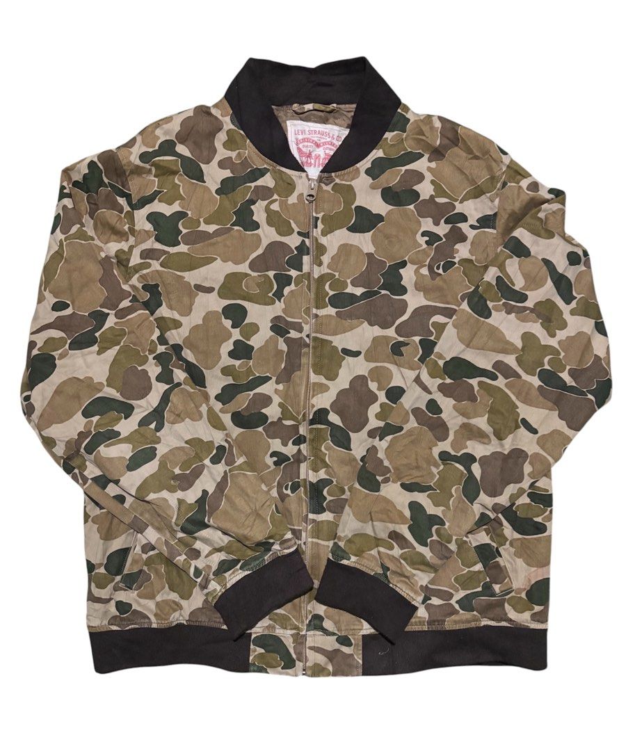 Levi's Camouflage Bomber Jacket Size XL (Category: Coats, Jackets and Outerwear) located in Manila. Submitted by kyosei00 (Listing ID 1465314131, Image 1). Description: - Brand: Levi's - Item: Camouflage Bomber Jacket - Size: XL - Origin: Made in Bangladesh - Closure: Full front zip - Details: Brown ribbed collar, cuffs, and hem, fully lined interior - Style: Utility aesthetic, perfect for everyday wear.