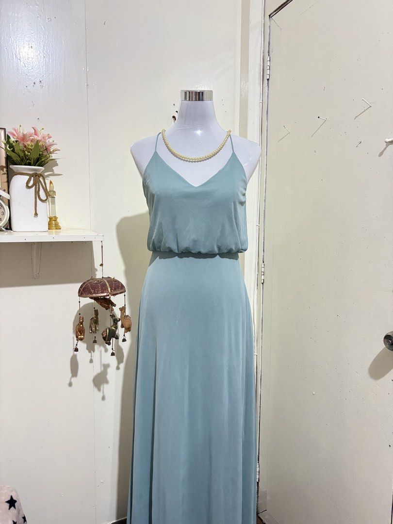 Light Blue V-Neck Maxi Dress Spaghetti Strap (Category: Dresses) located in Batangas. Submitted by lilirosie (Listing ID 1465188089, Image 1). Description: - Color: Sage light blue - Style: Maxi dress with V-neck and thin spaghetti straps - Fit: Fitted waist with flattering gathered fabric detail on top - Skirt: Long, flowing skirt with a floor-length hem - Back: Trendy criss-cross strap design - Condition: Excellent / Brand New.