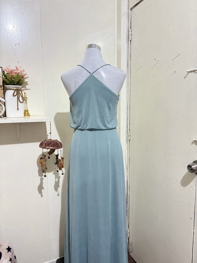 Light Blue V-Neck Maxi Dress Spaghetti Strap (Category: Dresses) located in Batangas. Submitted by lilirosie (Listing ID 1465188089, Image 3). Description: - Color: Sage light blue - Style: Maxi dress with V-neck and thin spaghetti straps - Fit: Fitted waist with flattering gathered fabric detail on top - Skirt: Long, flowing skirt with a floor-length hem - Back: Trendy criss-cross strap design - Condition: Excellent / Brand New.
