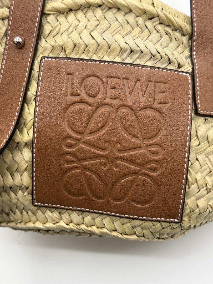 Loewe Basket (Category: Shoulder Bags) located in Caloocan City. Submitted by rossvault2 (Listing ID 1465235224, Image 2). Description: - Authentic Loewe basket bag crafted in Spain - Material: Natural palm leaf body with tan calfskin trim - Features iconic embossed anagram patch on the front - Adjustable leather top handles with sturdy metal hardware - Classic structured woven design, ideal for summer and vacations - Includes verification authen