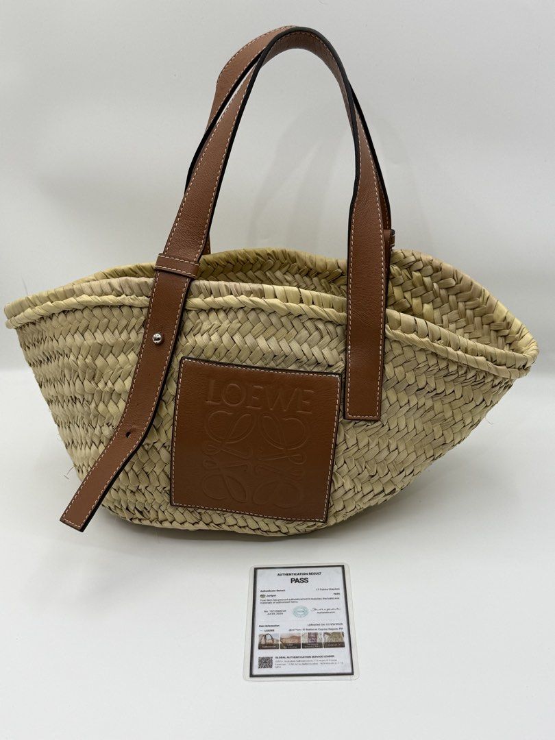 Loewe Basket (Category: Shoulder Bags) located in Caloocan City. Submitted by rossvault2 (Listing ID 1465235224, Image 1). Description: - Authentic Loewe basket bag crafted in Spain - Material: Natural palm leaf body with tan calfskin trim - Features iconic embossed anagram patch on the front - Adjustable leather top handles with sturdy metal hardware - Classic structured woven design, ideal for summer and vacations - Includes verification authen