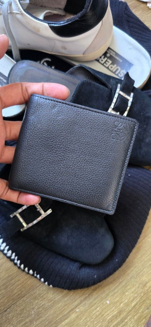 Loewe Black Leather Bifold Wallet (Category: Luxury Bags & Wallets) located in Quezon. Submitted by archivesss_666 (Listing ID 1465215980, Image 1). Description: - Authentic Loewe Bifold Wallet - Color: Classic Black - Material: Premium grained leather - Design: Embossed Loewe logo on front and inside flap - Interior: Multiple card slots and clean bill compartment - Authenticity: Includes serial number and 'Made in Spain' stamp - Condition: Excel