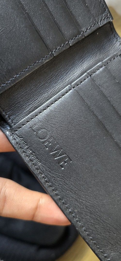 Loewe Black Leather Bifold Wallet (Category: Luxury Bags & Wallets) located in Quezon. Submitted by archivesss_666 (Listing ID 1465215980, Image 3). Description: - Authentic Loewe Bifold Wallet - Color: Classic Black - Material: Premium grained leather - Design: Embossed Loewe logo on front and inside flap - Interior: Multiple card slots and clean bill compartment - Authenticity: Includes serial number and 'Made in Spain' stamp - Condition: Excel