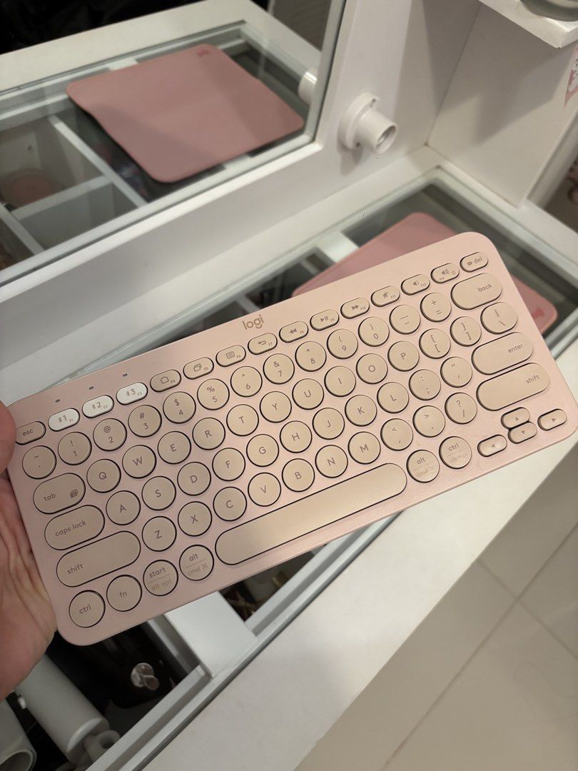 Logitech K380 Bluetooth Keyboard Rose Pink and Mouse pad (Category: Computer Keyboard) located in Taguig. Submitted by mommae_preloved (Listing ID 1465338753, Image 3). Description: Take both! - Model: Logitech K380 Wireless Keyboard - Color: Rose Pink (clean and tidy condition) - Features: Compact layout with cute round keys - Connectivity: Easy Bluetooth pairing across multiple devices - Power: Standard AAA battery setup - Freebie: Includes mat