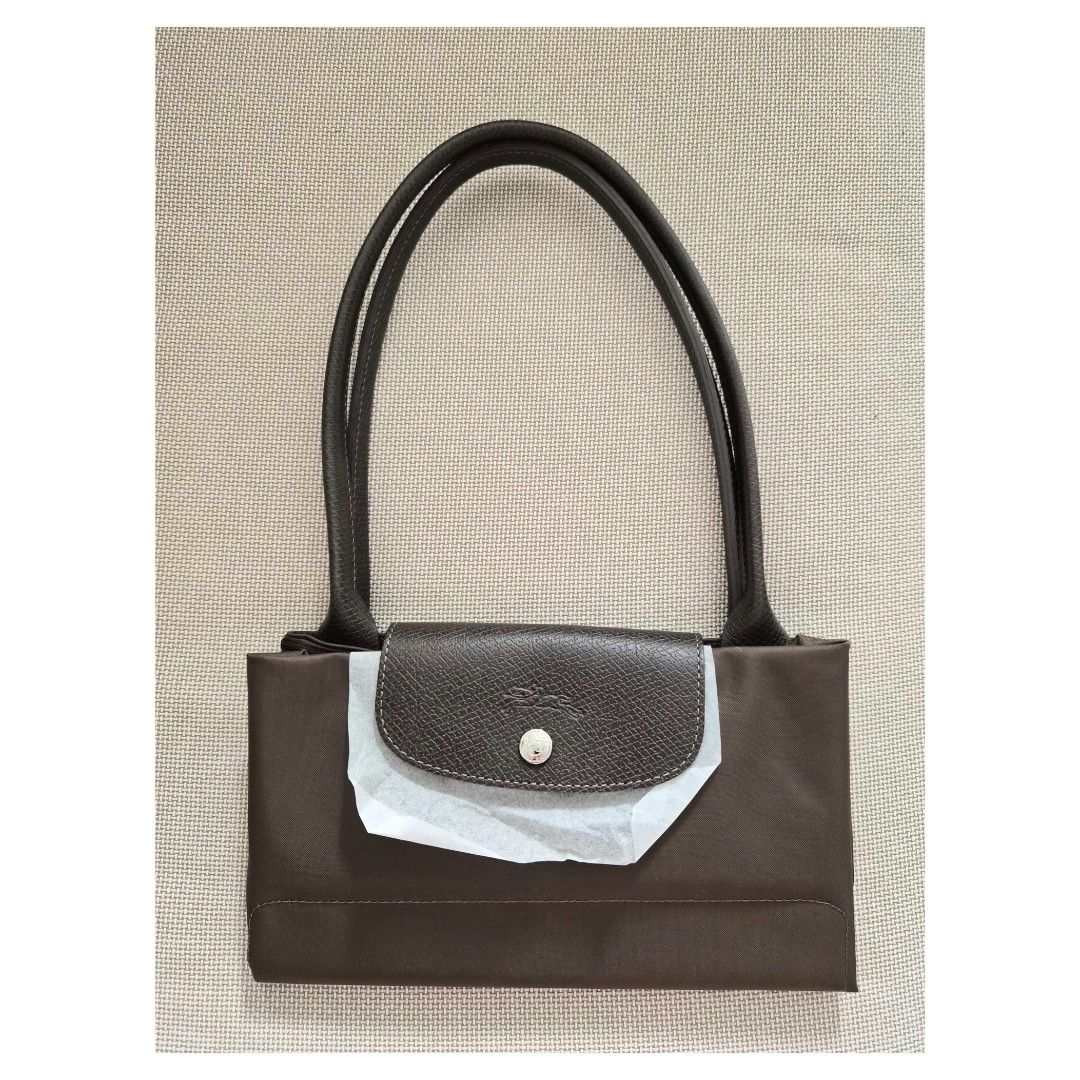 Longchamp Le Pliage LLH (Category: Luxury Bags & Wallets) located in Bacoor. Submitted by _sysells (Listing ID 1448764872, Image 1). Description: Longchamp Le Pliage Green in Terra. Size is large long handle. Purchased from Rustan's last year (see last photo for reference). Fits a 13" laptop. Inclusion: care card. RFS: Downsizing my bag collection..