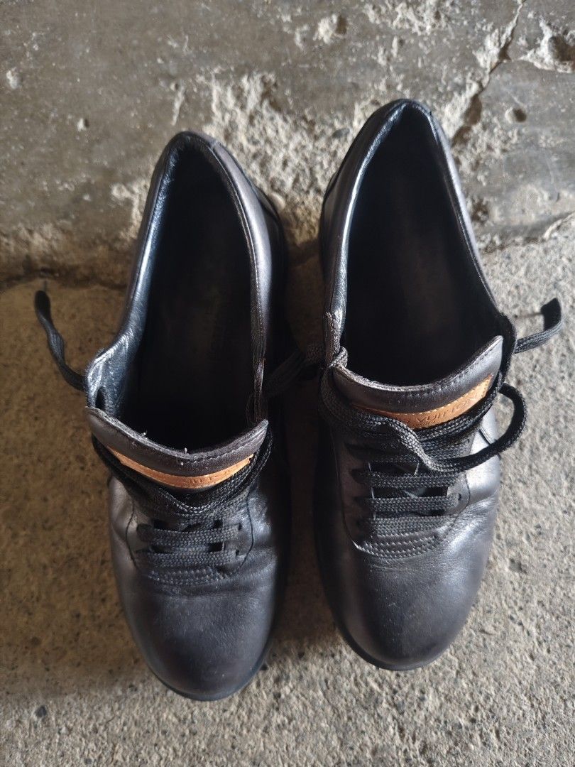 Louis Vuitton Black Leather Sneakers (Category: Sneakers & Footwear) located in Manila. Submitted by joshespino71762 (Listing ID 1465178577, Image 3). Description: Black leather sneakers by Louis Vuitton. Tan leather patch on the tongue with embossed logo branding. Louis Vuitton text stamped along the midsole. Gum rubber soles with LV square monogram detail on the bottom. Black laces. Regular fit, classic low-top silhouette..