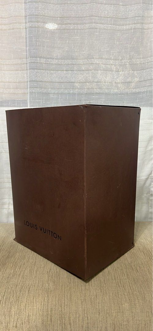 Louis Vuitton Brown Paper Box Packaging (Category: Luxury Bags & Wallets) located in Manila. Submitted by brownqueen65310 (Listing ID 1465207040, Image 2). Description: Louis Vuitton Brown Paper Box Packaging - 100% Authentic Louis Vuitton brown paper box from a LV Noe - Dimensions: 13in x 10in x 18in - Tall rectangular design with classic black branding and hinged lid - Features stamped codes underneath: 412253 006 D61404 (Made in China) Conditi