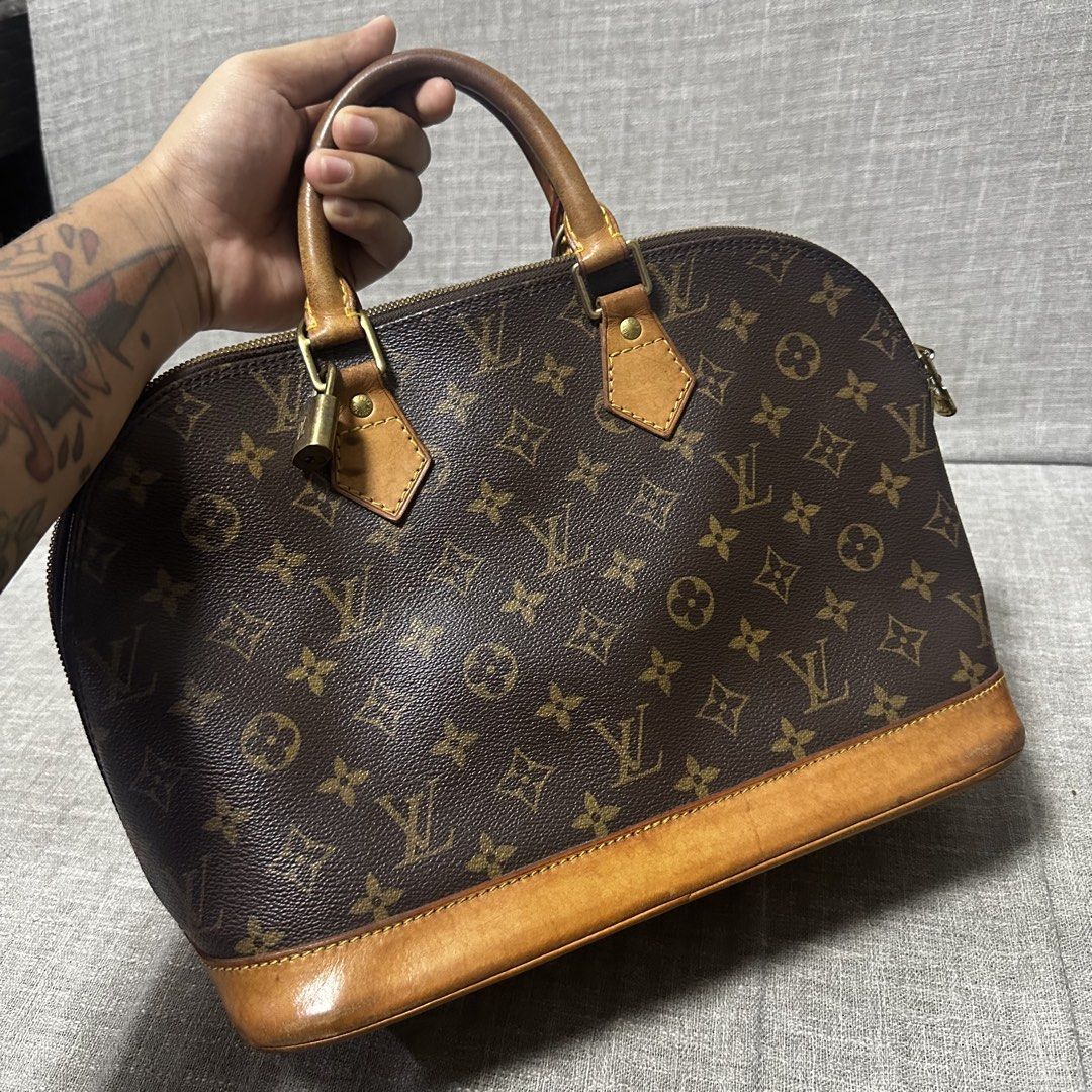 Louis Vuitton Monogram Alma Handbag (Category: Luxury Bags & Wallets) located in Quezon City. Submitted by retroboominwantsummoh (Listing ID 1465338580, Image 2). Description: - Authentic Louis Vuitton Monogram Canvas Handbag - Classic brown coated canvas with signature Monogram print - Vachetta leather base trim and dual rolled top handles with a beautiful natural patina - Secure top zip closure with attached padlock detail on the front handle -