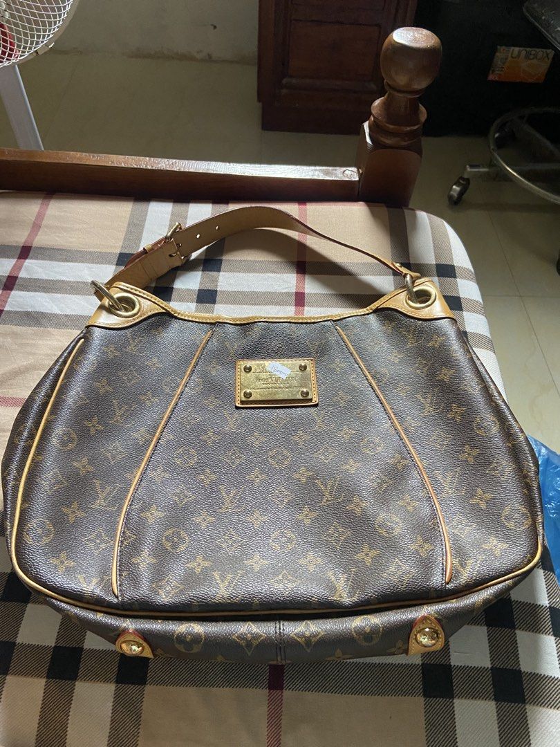 Louis Vuitton Monogram Canvas Hobo Handbag (Category: Luxury Bags & Wallets) located in Calamba. Submitted by mj_sotto22 (Listing ID 1465225843, Image 1). Description: Classic Monogram canvas with vachetta leather trim. Gold-tone metal Louis Vuitton Inventeur plaque on the front. Adjustable shoulder strap with buckle hardware. Spacious interior lined with fabric. Structured slouchy hobo silhouette with reinforced corners and gold feet at the bott