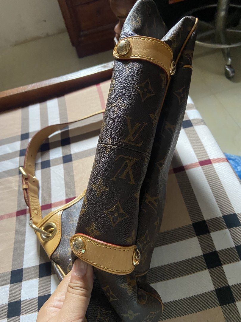 Louis Vuitton Monogram Canvas Hobo Handbag (Category: Luxury Bags & Wallets) located in Calamba. Submitted by mj_sotto22 (Listing ID 1465225843, Image 2). Description: Classic Monogram canvas with vachetta leather trim. Gold-tone metal Louis Vuitton Inventeur plaque on the front. Adjustable shoulder strap with buckle hardware. Spacious interior lined with fabric. Structured slouchy hobo silhouette with reinforced corners and gold feet at the bott