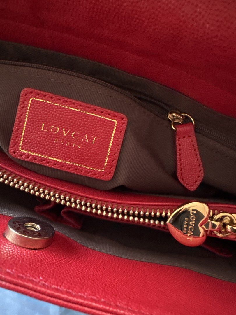 Lovcat Paris Red Quilted Leather Handbag (Category: Luxury Bags & Wallets) located in Caloocan City. Submitted by mysticmauee (Listing ID 1465191784, Image 2). Description: - Brand: Lovcat Paris - Material: Red quilted leather with gold hardware - Straps: Gold chain interwoven with red leather - Has sling slots on the sides but does not come with any shoulder sling strap - Closure: Secure magnetic snap - Interior: Brown fabric lining with multipl