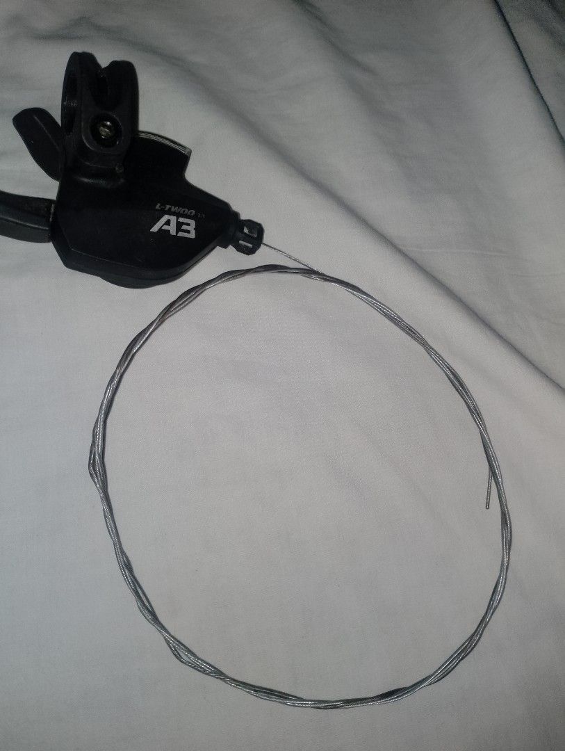 L-TWOO A3 Bicycle Shifter with Cable (Category: Bicycles) located in Manila. Submitted by cy_thrift (Listing ID 1465331076, Image 1). Description: - Brand: L-TWOO A3 shifter unit - Includes: Matching gear cable - Color: Black housing with white branding text - Condition: Works smoothly, great performance - Best for: Mountain bikes or commuter setups - Perfect as a reliable replacement part.
