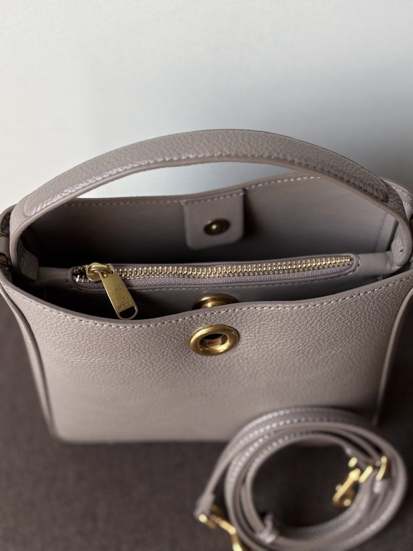 MANGO Bucket Bag | Taupe Handbag (Category: Shoulder Bags) located in Manila. Submitted by thecloseteditph (Listing ID 1465256118, Image 2). Description: • Authentic MANGO • Taupe color • Bucket bag design • Gold-tone metal detail • Short handle • Detachable & adjustable long strap • Interior zip pocket • Clean and well-maintained • Excellent pre-owned condition • No major flaws 📌 Bag + long strap included 📌 Selling because no longer used..