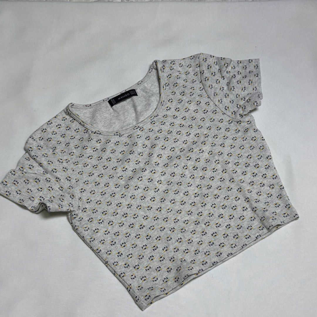 Mango Grey Floral Print Ribbed Crop Top (Category: Sleeveless) located in Santa Rosa. Submitted by kym_11 (Listing ID 1465335135, Image 1). Description: - Brand: Mango - Style: Ribbed crop top with short sleeves and round neckline - Design: Cute all-over tiny flower print - Material: Soft, textured fabric with great stretch - Fit: Comfortable for everyday casual wear.