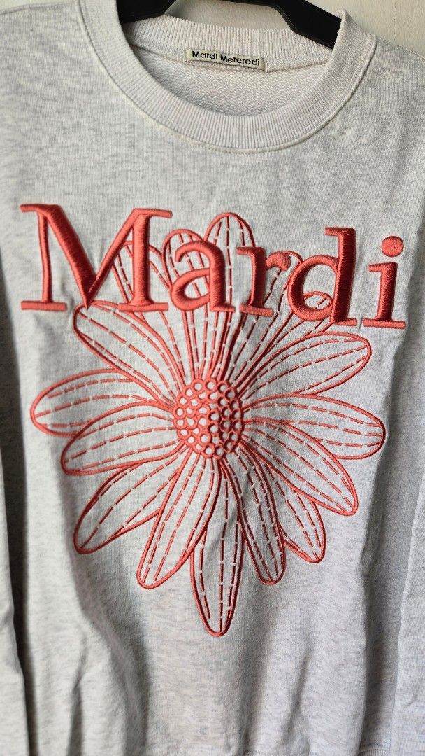 Mardi Mercredi Grey Flower Sweatshirt (Category: Longsleeves) located in Manila. Submitted by gratsimaravilla (Listing ID 1465189313, Image 2). Description: Grey marled sweatshirt from Mardi Mercredi. Large coral pink embroidered flower graphic on the front with bold red lettering. Crew neck style with ribbed cuffs and hem. Soft fleece lining inside. Has a small faint spot on the upper right sleeve near the shoulder. Comfortable oversized fit..