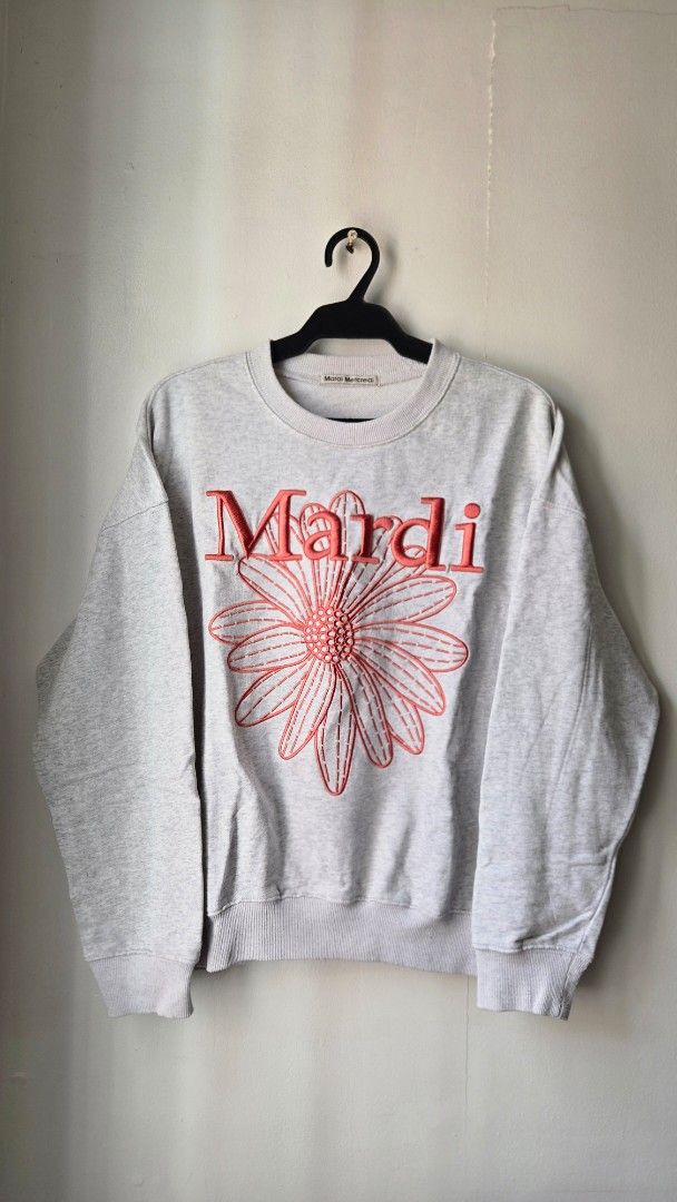 Mardi Mercredi Grey Flower Sweatshirt (Category: Longsleeves) located in Manila. Submitted by gratsimaravilla (Listing ID 1465189313, Image 1). Description: Grey marled sweatshirt from Mardi Mercredi. Large coral pink embroidered flower graphic on the front with bold red lettering. Crew neck style with ribbed cuffs and hem. Soft fleece lining inside. Has a small faint spot on the upper right sleeve near the shoulder. Comfortable oversized fit..