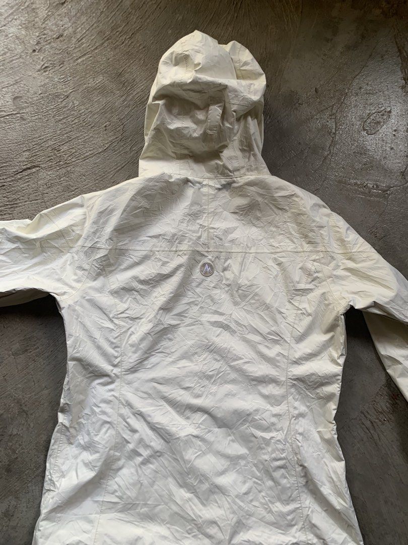 Marmot Cream Hooded Rain Jacket (Category: Coats, Jackets and Outerwear) located in Manila. Submitted by armamentoj94205 (Listing ID 1465176364, Image 2). Description: - Brand: Marmot - Color: Cream - Style: Lightweight hooded rain jacket with full zip closure and adjustable hood - Branding: Embroidered logo on chest and small logo patch on back yoke - Condition: Good practical condition, with minor interior lining peeling along the collar seam -