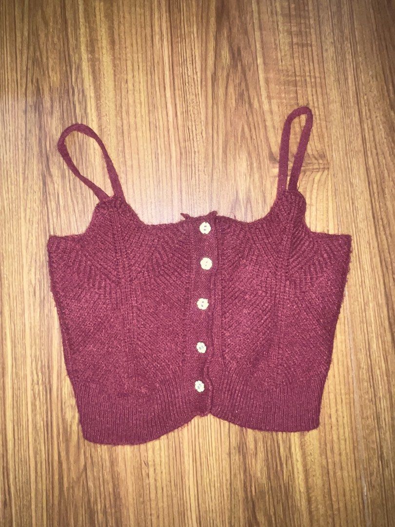 Maroon Knit Crop Top Camisole with Buttons (Category: Sleeveless) located in Marikina City. Submitted by owloui (Listing ID 1465319293, Image 1). Description: rfs: decluttering ‼️ NO COD Color: Maroon (will fit xs-s) Condition: Brand new (only used once for an event) Style: Sleeveless crop top with thin straps and Front button-up with cute white floral-shaped buttons Material: Soft textured knit fabric with ribbed hem.