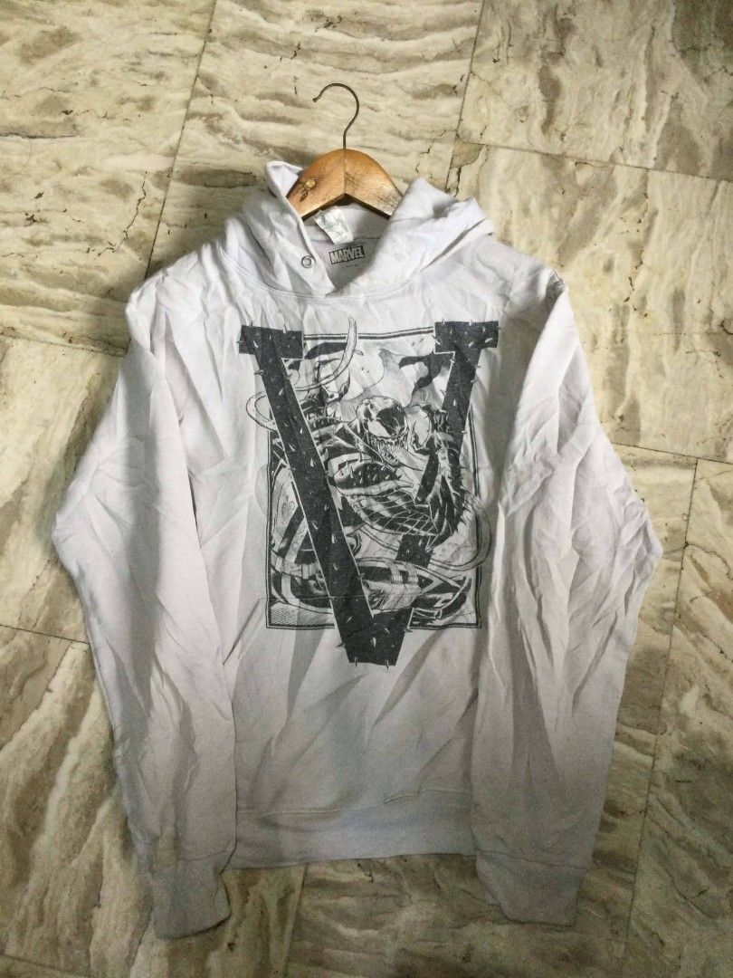 Marvel Venom Graphic White Hoodie (Category: Hoodies) located in Calumpit. Submitted by kylus_asten17 (Listing ID 1465327668, Image 1). Description: - Color: White - Design: Large Venom graphic print on front - Style: Classic pullover hoodie with front pocket and standard fit - Condition: Good, with light wrinkling from storage (needs a quick iron) - Perfect for daily casual wear.