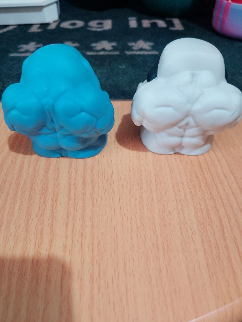 Marvel Venom Squishers Figures (Category: Figurines & Statues) located in Manila. Submitted by boyhet.thrift15 (Listing ID 1465323646, Image 2). Description: Two Marvel Venom figures. Blue one has classic white eyes and spider logo on chest. White one features dark mask with red eyes and spider logo. Squeeze style toys with muscular body shapes. Hasbro 2019 copyright stamped on the bottom of the blue figure. Minor paint wear on the teeth and eyes