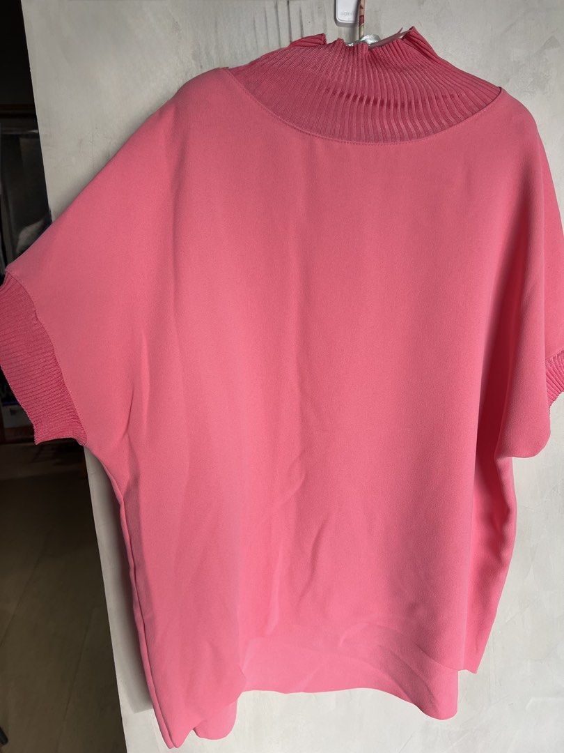 Max Mara Studio Pink Ribbed Knit Mock Neck Blouse (Category: Blouses) located in Manila. Submitted by elegantchic21 (Listing ID 1465296939, Image 2). Description: - Brand: Max Mara Studio - Color: Salmon Pink - Size: Large (tag attached) - Design: Light weight, short-sleeve top with ribbed mock neckline and matching sleeve cuffs - Can wear this with leggings or pants - Fabric: Smooth, crepe-like body - Fit: Relaxed torso with a slightly longer ba