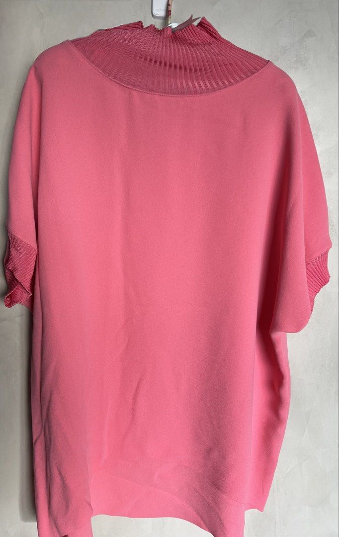 Max Mara Studio Pink Ribbed Knit Mock Neck Blouse (Category: Blouses) located in Manila. Submitted by elegantchic21 (Listing ID 1465296939, Image 1). Description: - Brand: Max Mara Studio - Color: Salmon Pink - Size: Large (tag attached) - Design: Light weight, short-sleeve top with ribbed mock neckline and matching sleeve cuffs - Can wear this with leggings or pants - Fabric: Smooth, crepe-like body - Fit: Relaxed torso with a slightly longer ba