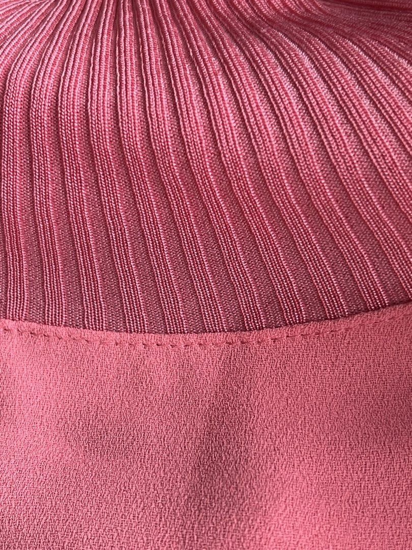 Max Mara Studio Pink Ribbed Knit Mock Neck Blouse (Category: Blouses) located in Manila. Submitted by elegantchic21 (Listing ID 1465296939, Image 3). Description: - Brand: Max Mara Studio - Color: Salmon Pink - Size: Large (tag attached) - Design: Light weight, short-sleeve top with ribbed mock neckline and matching sleeve cuffs - Can wear this with leggings or pants - Fabric: Smooth, crepe-like body - Fit: Relaxed torso with a slightly longer ba