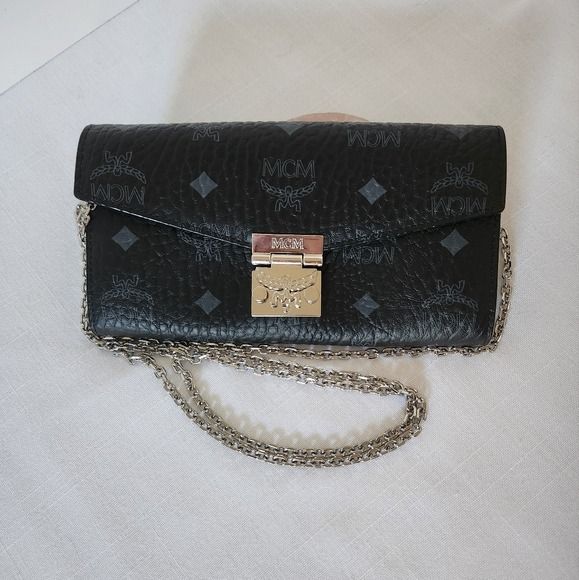 MCM Black Monogram Leather Chain Crossbody Bag (Category: Luxury Bags & Wallets) located in Caloocan City. Submitted by grandhorse-c5575b (Listing ID 1465214488, Image 1). Description: - Authentic MCM black leather crossbody bag with all-over monogram print - Elegant silver-tone hardware and matching chain strap - Secure front flap closure with metal lock - Fabric-lined interior featuring a convenient zip pocket - MCM München branding and product