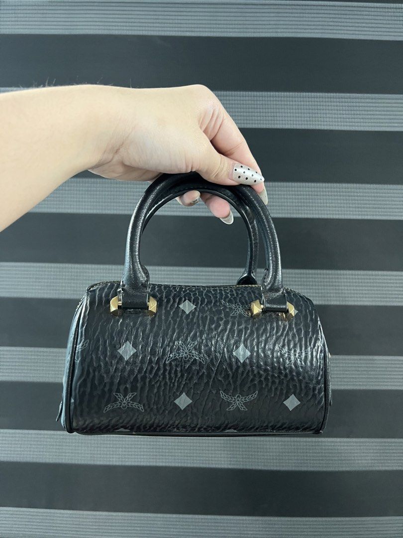 MCM Black Monogram Mini Boston Bag Crossbody (Category: Luxury Bags & Wallets) located in Angeles City. Submitted by camieday24 (Listing ID 1465285878, Image 2). Description: - INSP MCM Mini Boston Bag in classic black monogram print - Premium textured leather with polished gold-tone hardware - Zip-top closure for secure storage - Includes a detachable strap for crossbody or shoulder wear, plus top handles - Compact and lightweight, fits daily sm