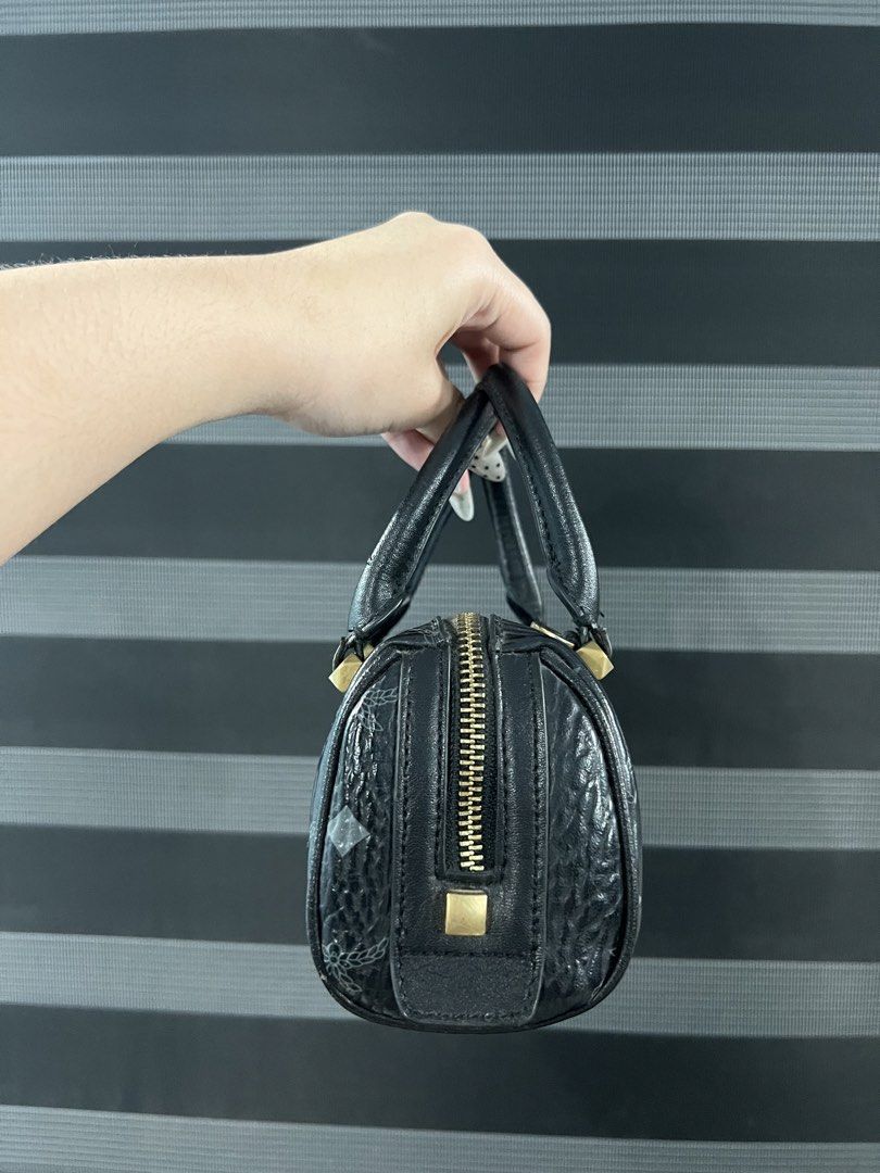 MCM Black Monogram Mini Boston Bag Crossbody (Category: Luxury Bags & Wallets) located in Angeles City. Submitted by camieday24 (Listing ID 1465285878, Image 3). Description: - INSP MCM Mini Boston Bag in classic black monogram print - Premium textured leather with polished gold-tone hardware - Zip-top closure for secure storage - Includes a detachable strap for crossbody or shoulder wear, plus top handles - Compact and lightweight, fits daily sm
