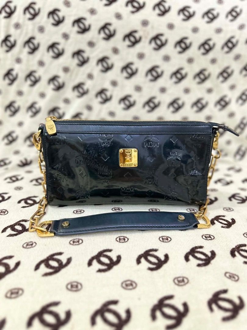 MCM Black Patent Leather Shoulder Bag (Category: Luxury Bags & Wallets) located in San Pedro. Submitted by silverlion-4d46 (Listing ID 1465214204, Image 1). Description: - Brand: MCM - Material: Glossy black patent leather with debossed monogram - Hardware: Gold-tone - Strap: Chunky chain strap with comfortable leather shoulder pad - Closure: Top zipper - Details: Front gold MCM logo plaque - Style: Compact, versatile for day-to-night wear - Cond