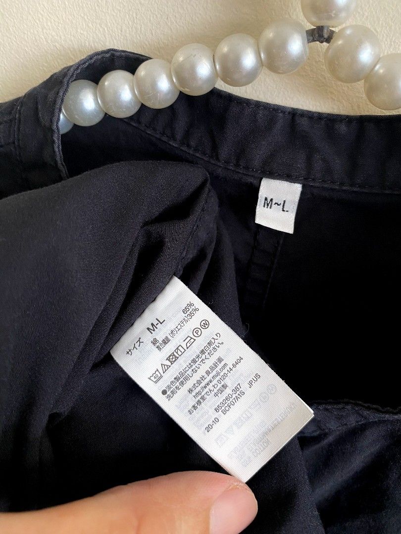 Medium - Large Muji Snap Button Blouse (Category: Others Tops) located in Castillejos. Submitted by lalainecloset22 (Listing ID 1465242770, Image 3). Description: - Brand: Muji - Item: Snap Button Blouse - Color: Black - Size: M-L (Medium to Large) - Material: 65% Cotton, 35% Polyester (breathable and easy to wash) - Condition: 9/10 good pre-loved condition - Features: Snap button closure, mandarin-style collar, short sleeves, relaxed fit - Ideal