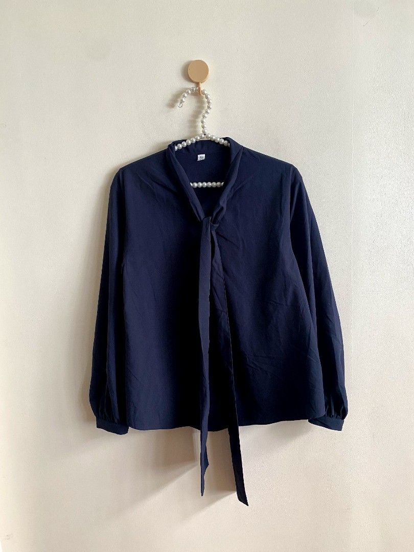 Medium GU (Category: Others Tops) located in Castillejos. Submitted by lalainecloset22 (Listing ID 1465242074, Image 3). Description: - Brand: GU - Size: Medium (160/84A) - Color: Dark Navy Blue - Material: 100% Polyester (59% recycled polyester fiber) - Features: Elegant tie-neck bow, trendy puff sleeves, smooth fabric - Condition: Excellent (Layered Condition 4) - Perfect for: Office wear, formal events, or smart-casual OOTDs.