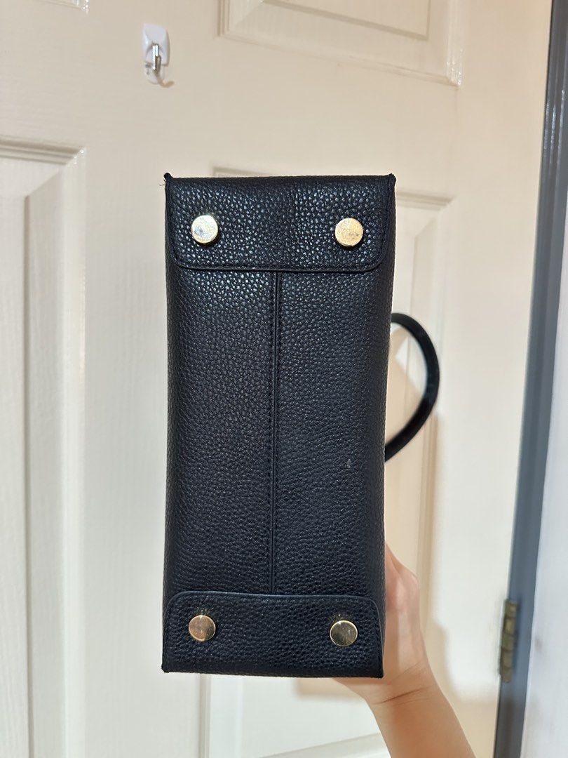 Michael Kors Black Pebbled Leather Tote Handbag (Category: Tote Bags) located in Manila. Submitted by ktyyycloset (Listing ID 1465332563, Image 3). Description: - Brand: Michael Kors - Material: Black pebbled leather with gold foil logo - Hardware: Gold-tone with protective metal feet on the base - Design: Structured tote with double top handles and side gussets - Interior: Clean and spacious structure - Condition: Noticeable wear and peeling top