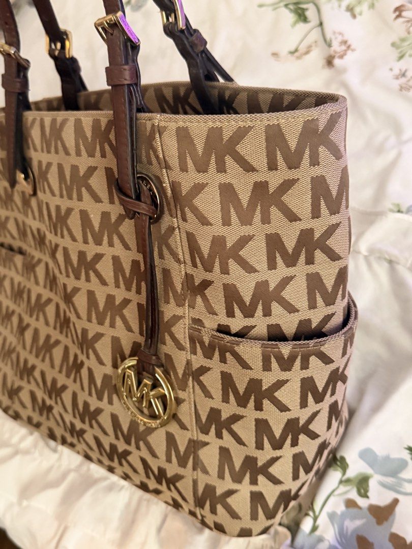 Michael Kors MK Monogram Brown Bag (Category: Shoulder Bags) located in Las Pinas. Submitted by kitkat333_ (Listing ID 1465314385, Image 3). Description: - Authentic Michael Kors tote in classic brown monogram - Elegant dark brown leather straps and gleaming gold-tone hardware, complete with MK charm - Intact leather - No stains/Signs of usage! - Secure top-zip closure to keep your belongings safe - Spacious fabric-lined interior with a middle zi