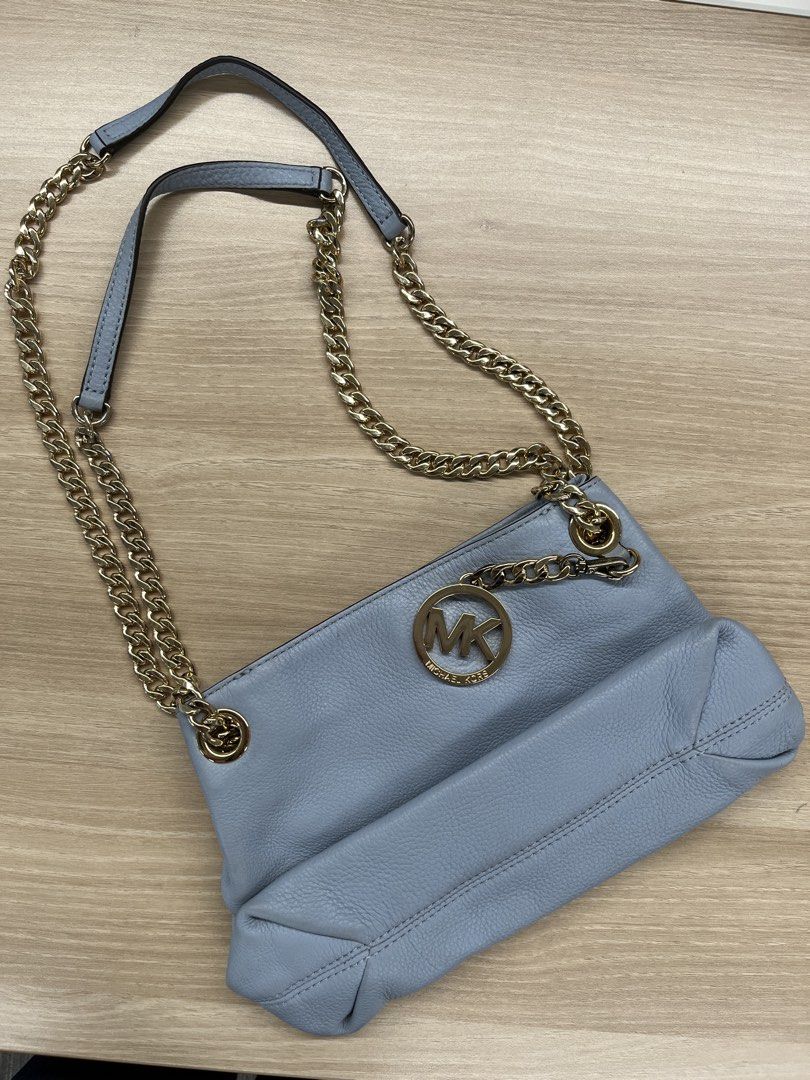 MICHAEL KORS (MK) Sling Bag 💙 (Category: Shoulder Bags) located in Tanza. Submitted by vhies_closet24 (Listing ID 1465182671, Image 1). Description: MICHAEL KORS (MK) Sling Bag 💙 Color: Light Blue With gold-tone chain strap 📌 Condition: Pre-loved • Has some faded areas and visible stains (see photos) • Still usable and overall intact • Selling as-is, please manage expectations RFS: Decluttering / no longer used.