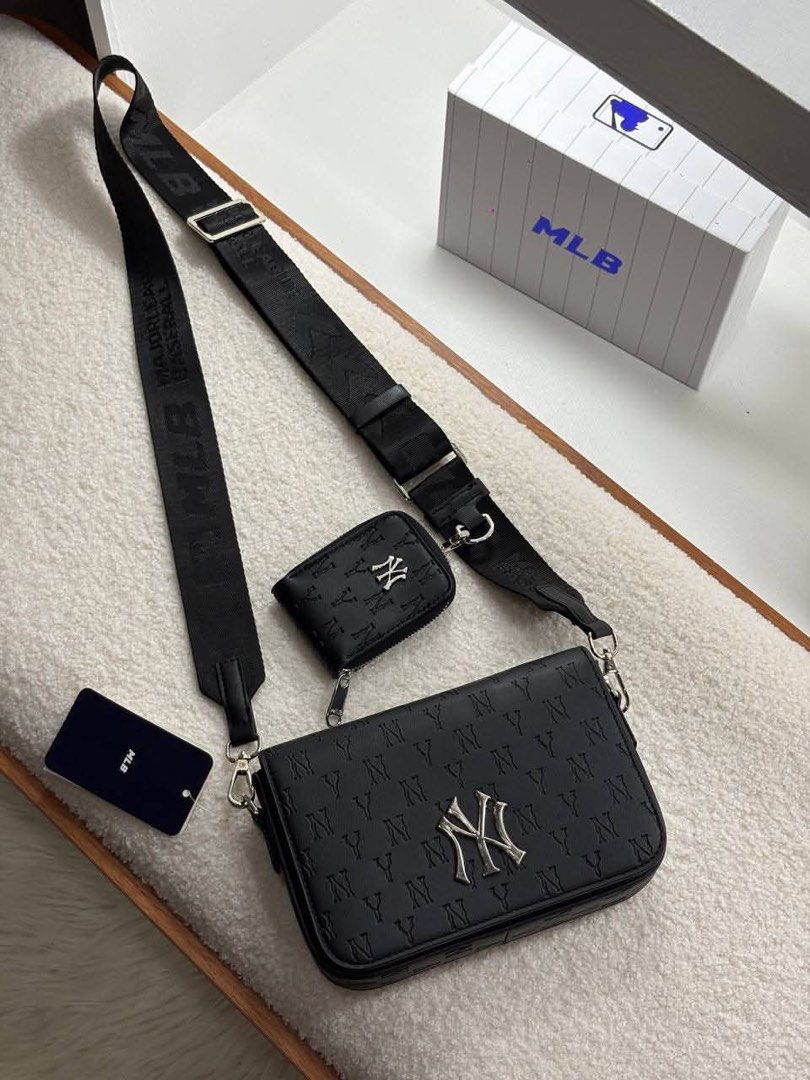 MLB Crossbody Bag Set Sling Bag (Category: Sling Bags) located in Manila. Submitted by sanghaya.mnl (Listing ID 1464923317, Image 1). Description: - Includes a matching mini pouch coin purse for extra storage - Features premium metal Yankees logo hardware on the front - Comfortable, adjustable wide webbing strap included - Color options: Classic Black or Clean White - Original branding tags attached.
