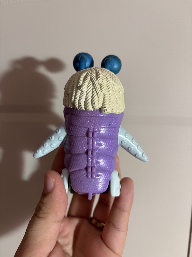 Monster’s Inc. Boo (Category: Figurines & Statues) located in Plaridel. Submitted by moddedjarvis (Listing ID 1465172606, Image 2). Description: - Authentic McDonald's Disney Pixar Monsters, Inc. toy - Features a purple quilted body, light blue limbs, and working rolling wheels - Unique design with two eyeballs and a wide mouth hiding a character inside - Stamped copyright text on the back - Condition: Shows minor scuffs and paint wear on the eye
