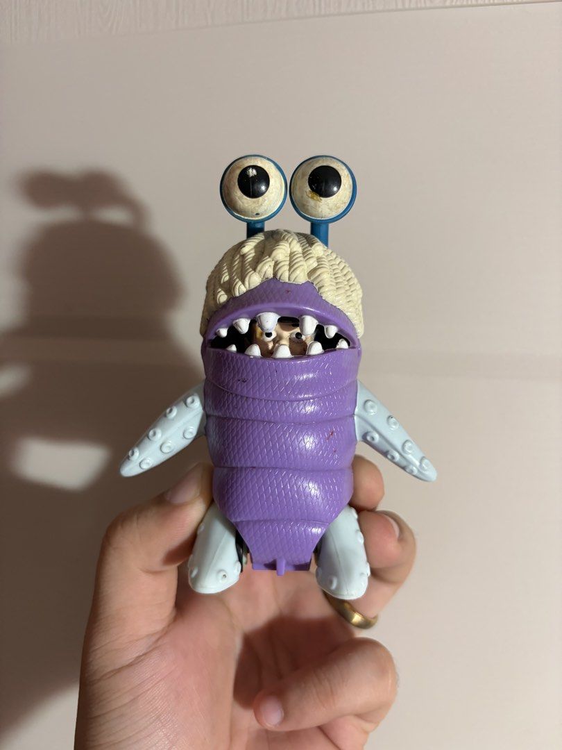 Monster’s Inc. Boo (Category: Figurines & Statues) located in Plaridel. Submitted by moddedjarvis (Listing ID 1465172606, Image 1). Description: - Authentic McDonald's Disney Pixar Monsters, Inc. toy - Features a purple quilted body, light blue limbs, and working rolling wheels - Unique design with two eyeballs and a wide mouth hiding a character inside - Stamped copyright text on the back - Condition: Shows minor scuffs and paint wear on the eye