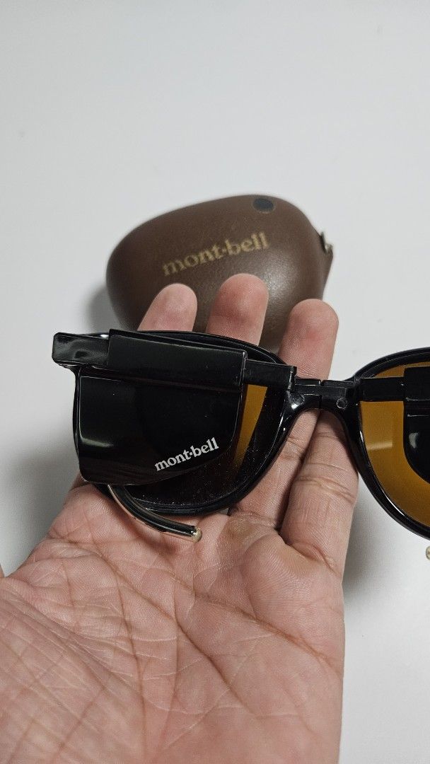 Montbell foldable sunglasses with case (Category: Sunglasses & Eyewear) located in Alfonso. Submitted by jbcamet (Listing ID 1465242649, Image 3). Description: - Brand: Montbell - Color: Dark brown frames and lenses - Feature: Unique foldable design that packs down super small - Inclusion: Matching brown textured hard case with snap closure - Detail: Branded text clearly stamped on the arm and case - Best for: Hiking, outdoor trips, and everyday 