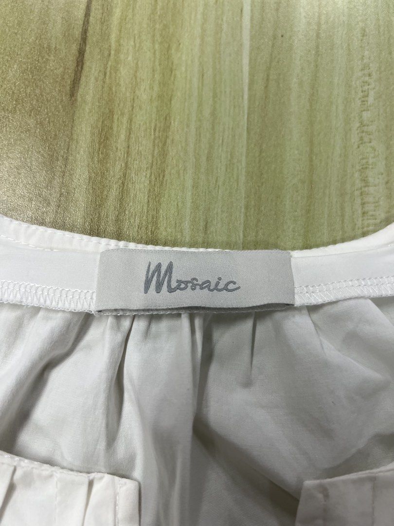 Mosaic White Puff Sleeve Blouse (Category: Blouses) located in Manila. Submitted by issie_07 (Listing ID 1465211818, Image 2). Description: - Color: Mosaic White - Fit: Loose and flowy through the body - Sleeves: Short puff sleeves - Neckline: Gathered with a small front slit - Fabric: Crisp, lightweight, and breathable cotton-like material - Condition: Excellent, with a clean collar tag.