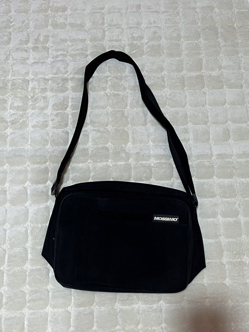 Mossimo Black Crossbody Messenger Bag (Category: Sling Bags) located in Dasmarinas. Submitted by gmxngmmd (Listing ID 1465359688, Image 1). Description: Black Mossimo Crossbody Messenger Bag - Black Mossimo messenger bag with adjustable strap - Multiple compartments inside, including pen slots and zippered pockets. - Front flap with velcro closure and small logo patch. - Clean interior lining. - Practical everyday size for school, work, or casual