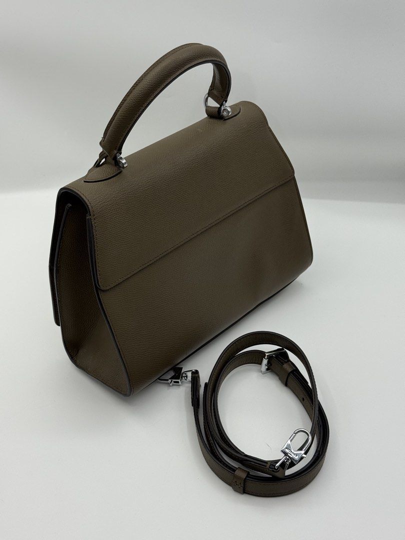 Moynat (Category: Cross-body Bags) located in Caloocan City. Submitted by rossvault2 (Listing ID 1465233809, Image 3). Description: - Moynat top handle bag in elegant taupe grained leather - Silver-tone hardware with a secure front twist-lock closure - Includes clochette with matching key and protective metal feet - Comes with the original detachable and adjustable shoulder strap - Impeccable condition: clean interior and crisp edges throughout -