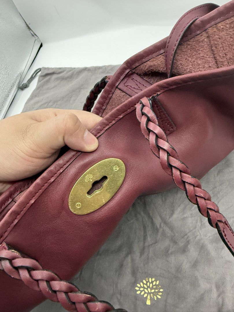 Mulberry (Category: Tote Bags) located in Caloocan City. Submitted by rossvault2 (Listing ID 1465227364, Image 3). Description: - Brand: Mulberry - Color: Rich burgundy - Material: Premium leather with unlined suede interior - Hardware: Gold-tone with signature postman's lock closure - Straps: Comfortable braided shoulder straps - Extras: Includes matching small zip pouch and original grey Mulberry dust bag - Condition: Spacious daily tote with a