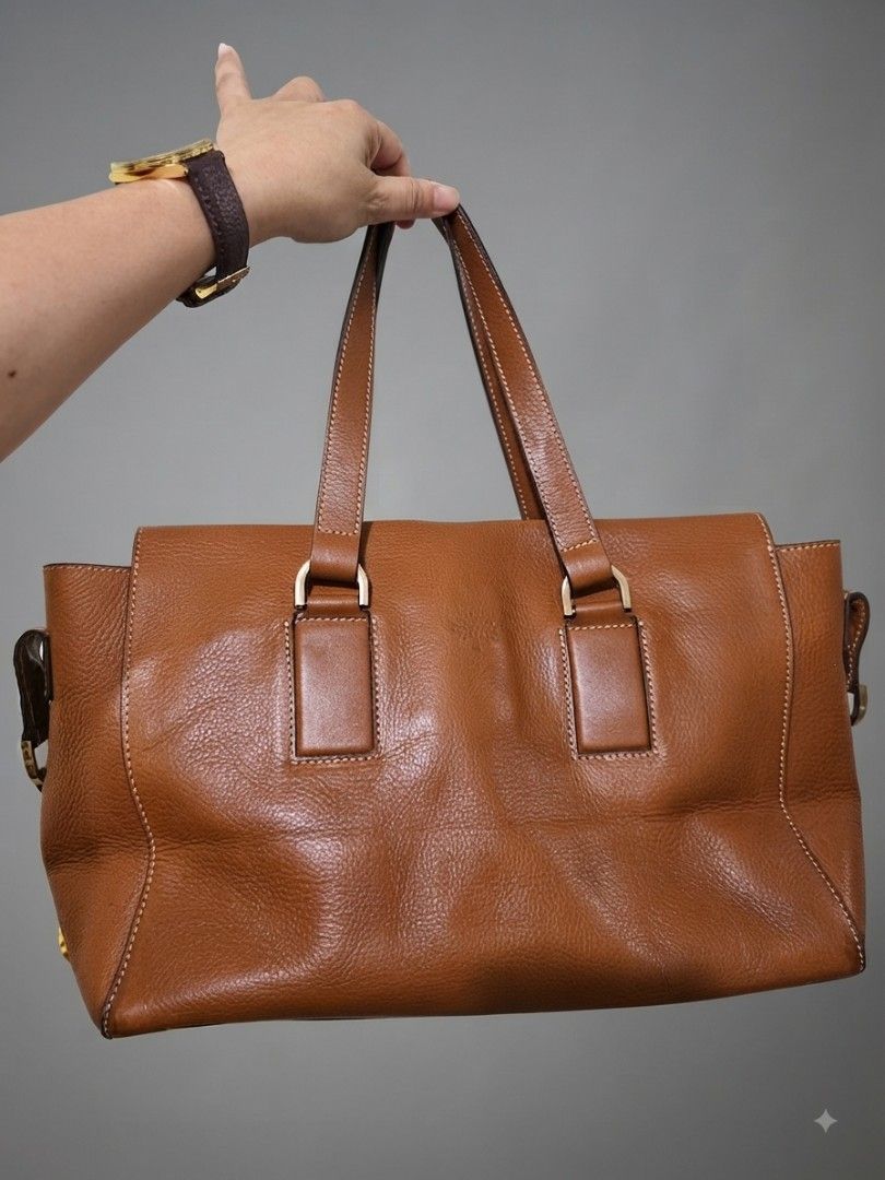 Mulberry Brown Leather Tote Handbag (Category: Luxury Bags & Wallets) located in Dasmarinas. Submitted by closetnqueens (Listing ID 1465296964, Image 1). Description: - Authentic Mulberry brown pebbled leather tote bag - Dual top handles and classic gold-tone hardware - Roomy interior with an inside zipper pocket and serial number tag - Clean lining throughout - Minor surface scratches on the metal plaque plate, but still a gorgeous everyday bag 
