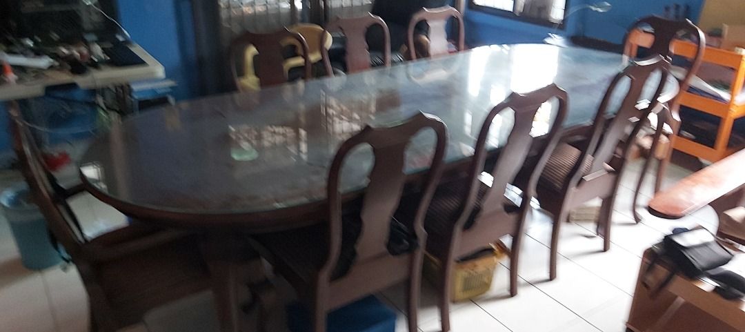 Narra 10-seater long dining table (Category: Everything Else Others) located in Quezon City. Submitted by low-ballers_will_be_blocked (Listing ID 1465226063, Image 3). Description: mint solid heavy Narra wood with glass top and original mint upholstery. 2 host / head chairs. since 1978.