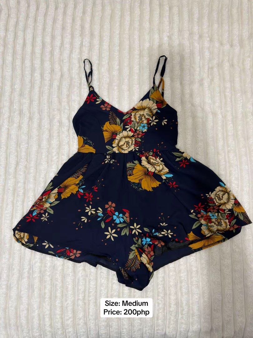 Navy Blue Floral Romper Spaghetti Strap Medium (Category: Rompers) located in Pasig City. Submitted by jamie.sebuc (Listing ID 1465237737, Image 1). Description: - Item: Navy Blue Floral Romper - Size: Medium - Price: ₱200 - Design: V-neckline, spaghetti straps, and flowy shorts with a skirt-like look - Material: Super comfortable and lightweight - Condition: Great for casual wear and hot days.